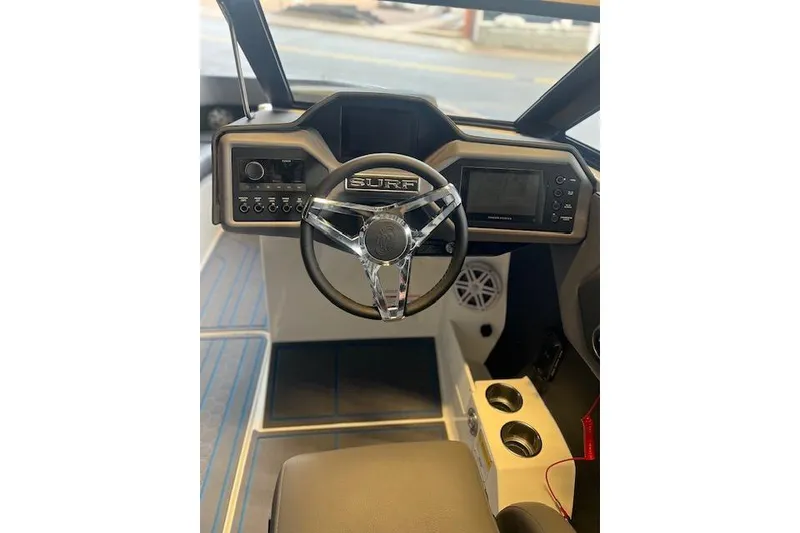 Slide: The Image of 2025 Cobalt CS23 Surf boat dashboard with steering wheel and control panel. - 7