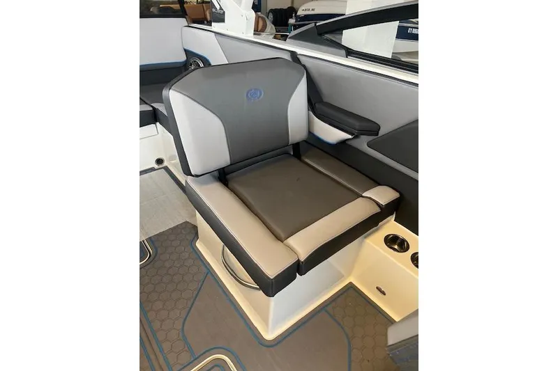 Slide: The Image of 2025 Cobalt CS23 Surf boat seat with gray and black upholstery, cup holders, and armrest. - 8