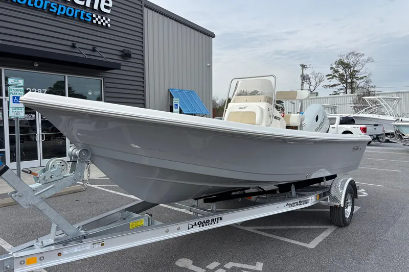 Slide: The Image of 2026 Bulls Bay 2000 boat on trailer outside dealership, featuring sleek design and Suzuki engine. - 1
