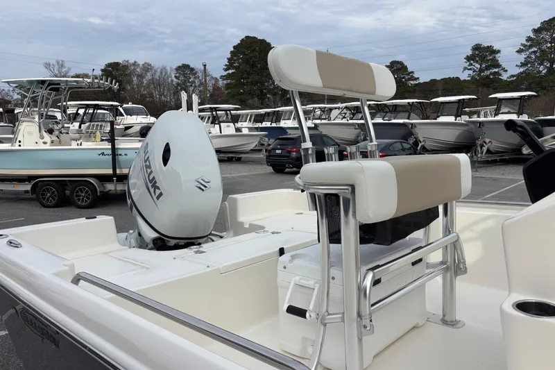 Slide: The Image of 2026 Bulls Bay 2000 boat with Suzuki engine in a marina setting. - 10