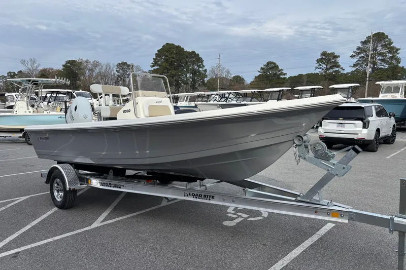 Slide: The Image of 2026 Bulls Bay 2000 boat on trailer in parking lot, surrounded by trees and vehicles. - 3
