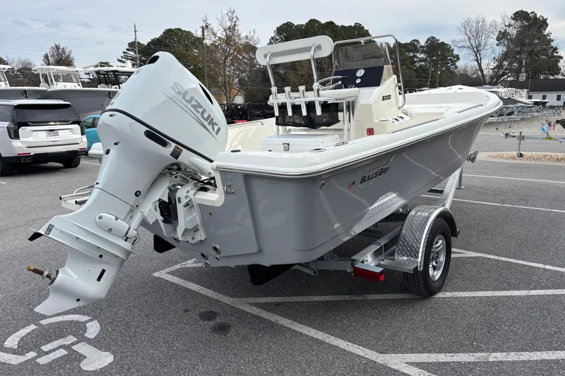 Slide: The Image of 2026 Bulls Bay 2000 boat with Suzuki outboard motor on trailer in parking lot. - 5