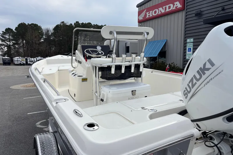 Slide: The Image of 2026 Bulls Bay 2000 boat with Suzuki engine, parked near Honda dealership. - 8