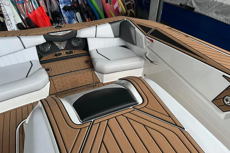 Slide: The Image of 2019 Nautique Ski Nautique interior with teak flooring and white seating. - 11