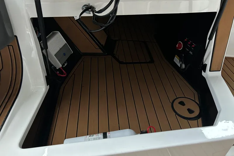 Slide: The Image of 2019 Nautique Ski Nautique interior with teak flooring and electronic components. - 20