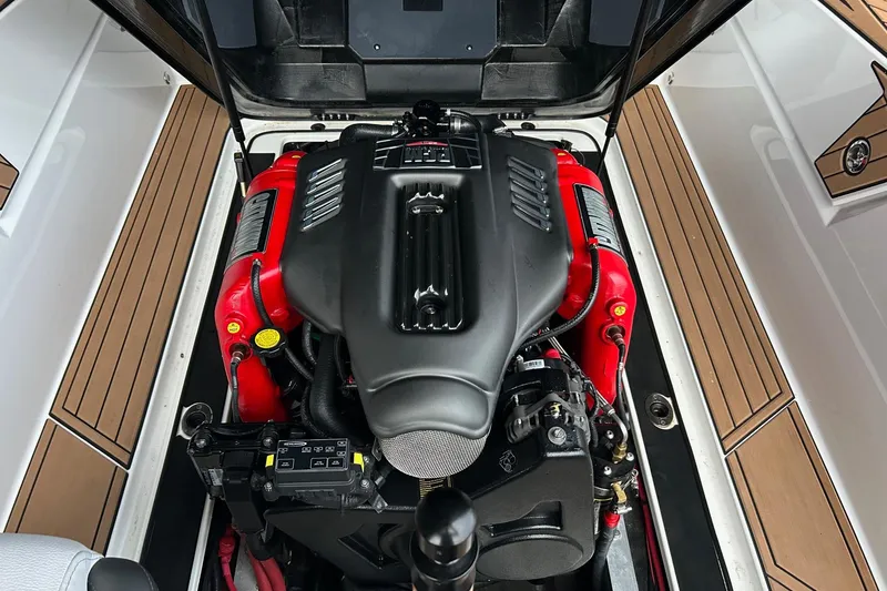 Slide: The Image of 2019 Nautique Ski Nautique engine compartment with red and black components, open hatch view. - 21