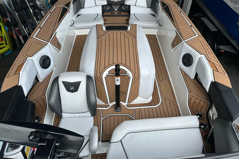 Slide: The Image of 2019 Nautique Ski Nautique interior with white seats and wood-style flooring. - 22