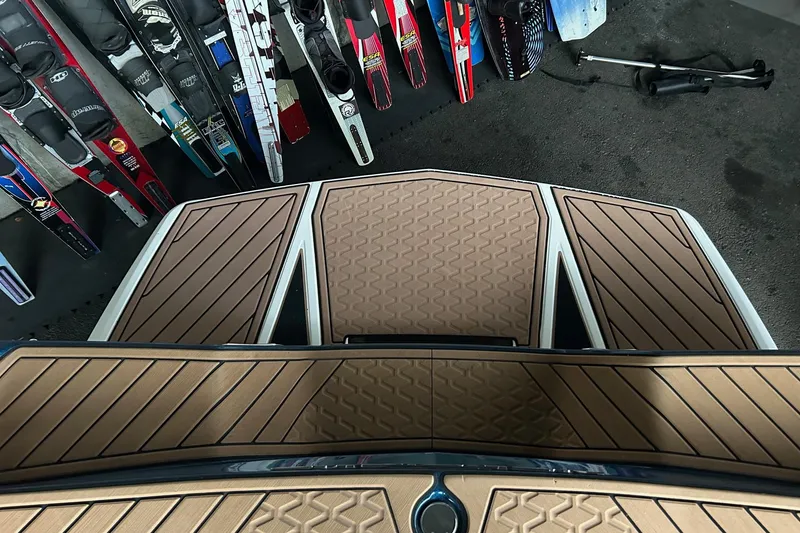 Slide: The Image of 2019 Nautique Ski Nautique boat deck with water skis in background. - 25