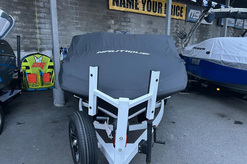 Slide: The Image of 2019 Nautique Ski Nautique boat covered, parked on trailer in storage area. - 27