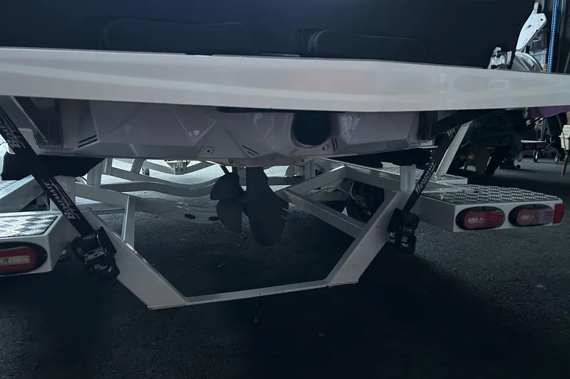 Slide: The Image of 2019 Nautique Ski Nautique boat on trailer, rear view showing propeller and trailer details. - 29