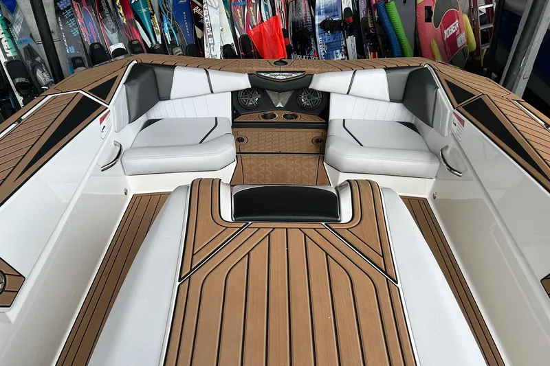 Slide: The Image of 2019 Nautique Ski Nautique boat interior with sleek seating and stylish wood finish. - 9