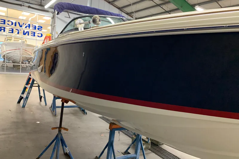 Slide: The Image of 2018 Chris-Craft Launch 23 boat in service center, side view. - 10
