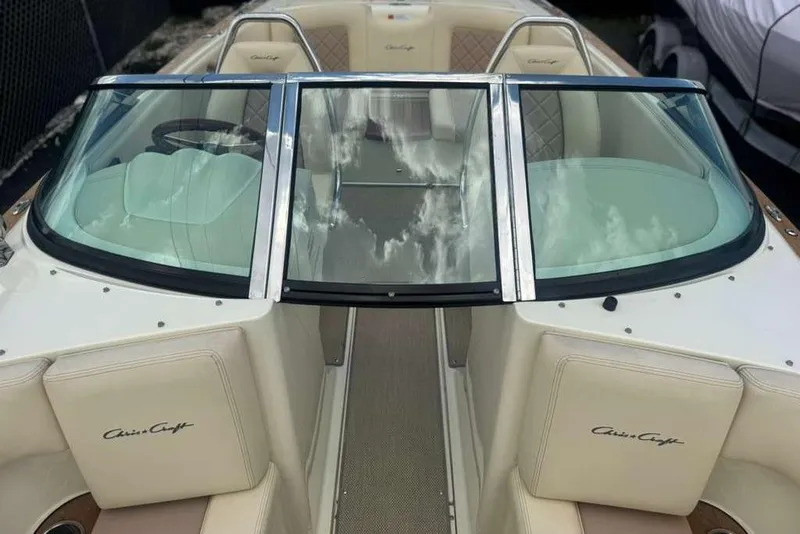 Slide: The Image of 2018 Chris-Craft Launch 23 boat interior with cream seats and glass windshield. - 14