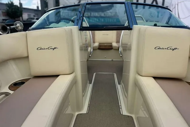 Slide: The Image of 2018 Chris-Craft Launch 23 boat interior with beige seating and logo detailing. - 15