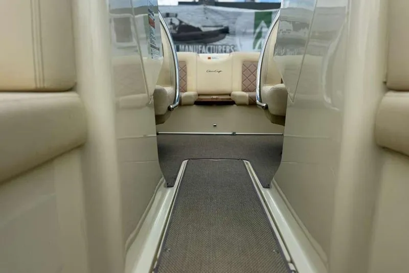 Slide: The Image of Interior view of a 2018 Chris-Craft Launch 23 boat, featuring elegant seating and carpeted flooring. - 16