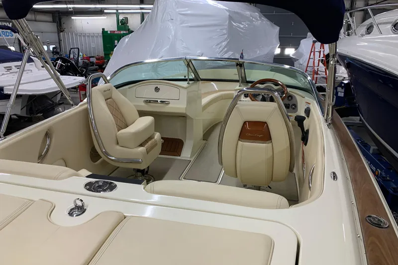 Slide: The Image of 2018 Chris-Craft Launch 23 boat interior with beige seating and polished details. - 22
