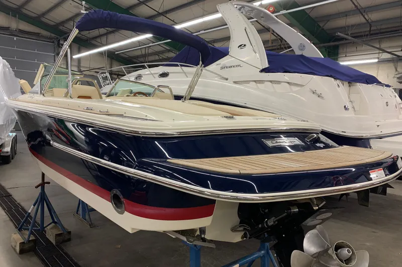 Slide: The Image of 2018 Chris-Craft Launch 23 boat in indoor storage, showcasing sleek design and luxury features. - 23