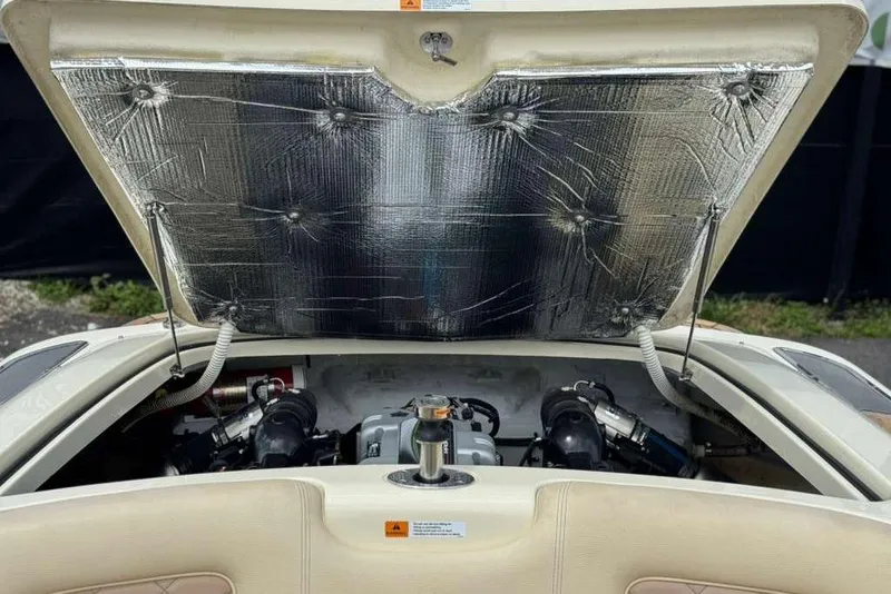 Slide: The Image of Open engine compartment of a 2018 Chris-Craft Launch 23 boat, showcasing engine details. - 26