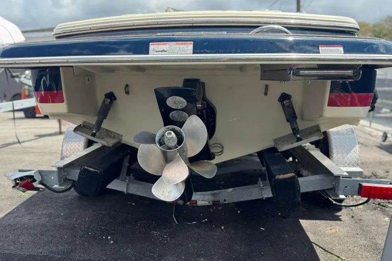Slide: The Image of Rear view of 2018 Chris-Craft Launch 23 boat on trailer, showcasing propeller and hull. - 28
