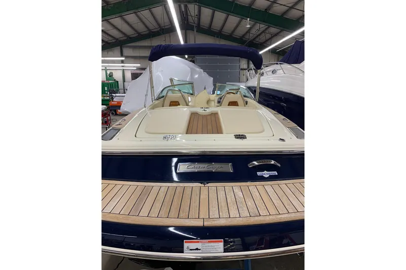 Slide: The Image of 2018 Chris-Craft Launch 23 boat with elegant wood deck in showroom. - 29