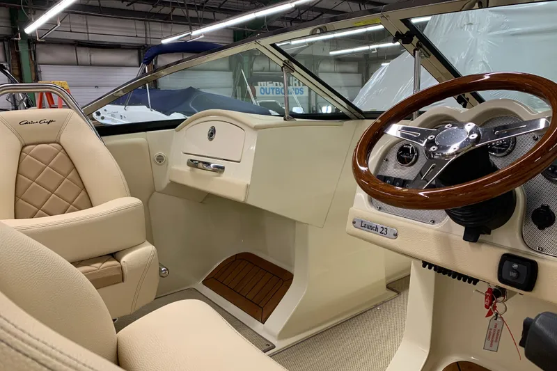 Slide: The Image of 2018 Chris-Craft Launch 23 boat interior with elegant steering wheel and luxurious seating. - 7