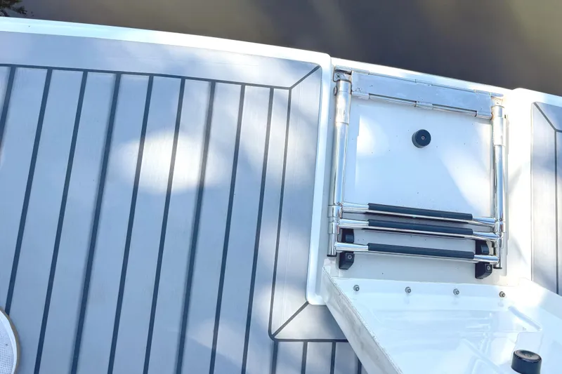 Slide: The Image of 2015 Formula 400 Super Sport boat deck with retractable ladder and person wearing sneakers. - 14