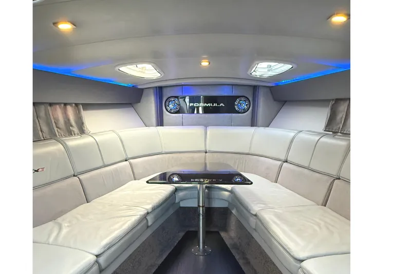 Slide: The Image of Luxurious interior of a 2015 Formula 400 Super Sport boat with plush seating and ambient lighting. - 23