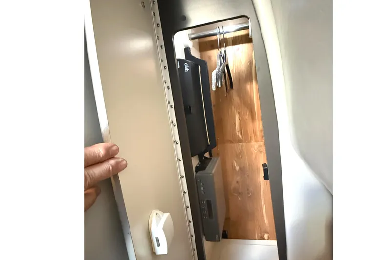 Slide: The Image of 2015 Formula 400 Super Sport interior storage compartment with wooden panel and hanging space. - 35