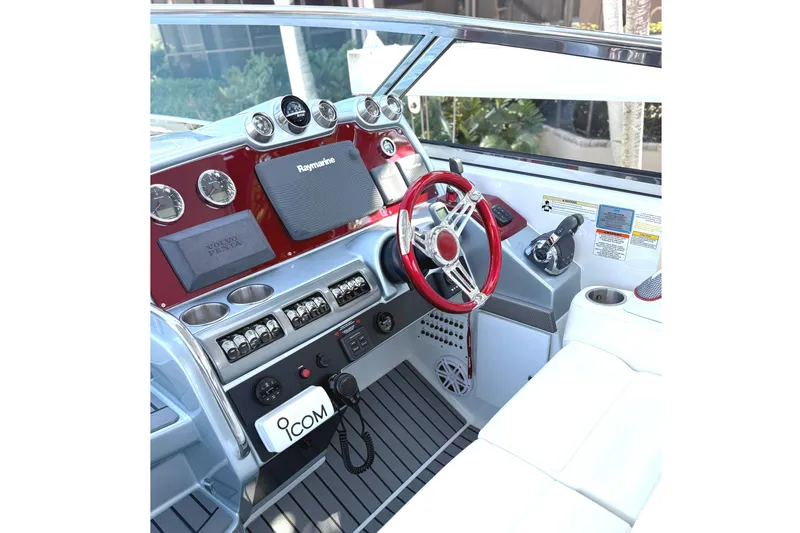 Slide: The Image of 2015 Formula 400 Super Sport boat cockpit with red steering wheel and modern controls. - 4