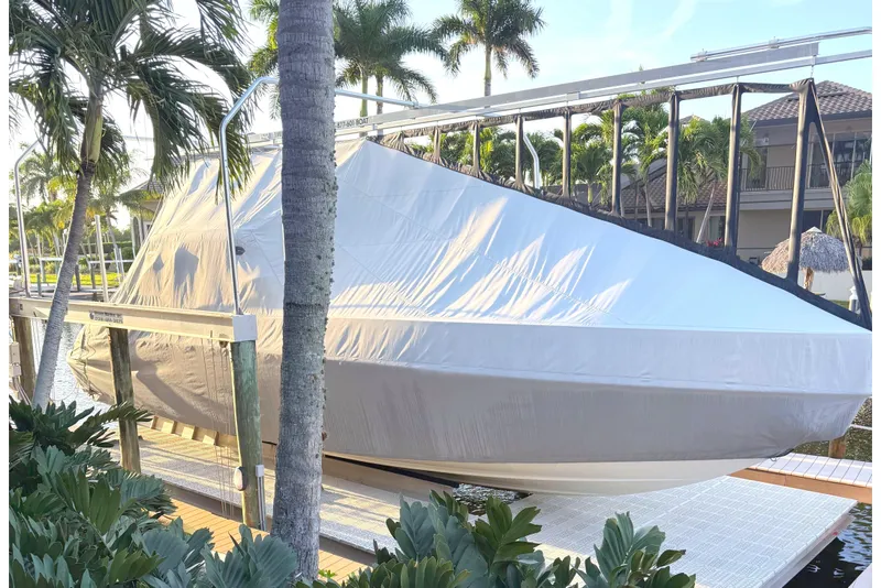 Slide: The Image of Covered 2015 Formula 400 Super Sport boat docked near tropical plants. - 43