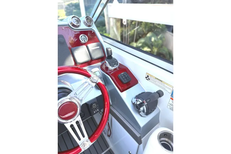 Slide: The Image of 2015 Formula 400 Super Sport boat cockpit with red steering wheel and control panel. - 5