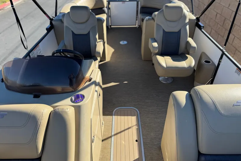 Slide: The Image of 2021 Starcraft SLS 3 boat interior with beige seating and steering console. - 14