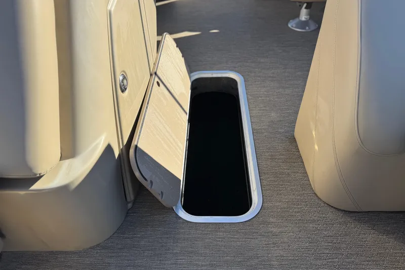 Slide: The Image of Open storage compartment on 2021 Starcraft SLS 3 boat, featuring beige interior. - 15