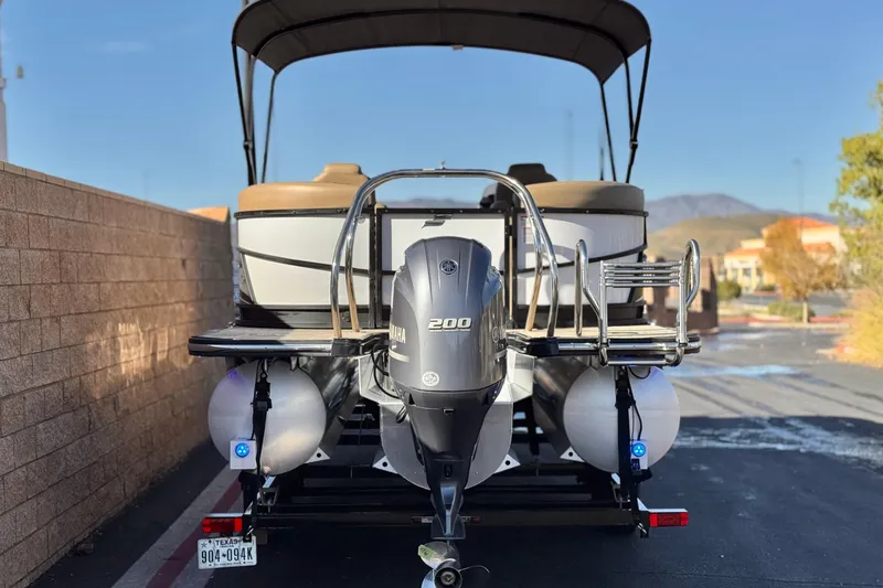 Slide: The Image of 2021 Starcraft SLS 3 pontoon boat with Yamaha 200 engine, parked outdoors. - 5