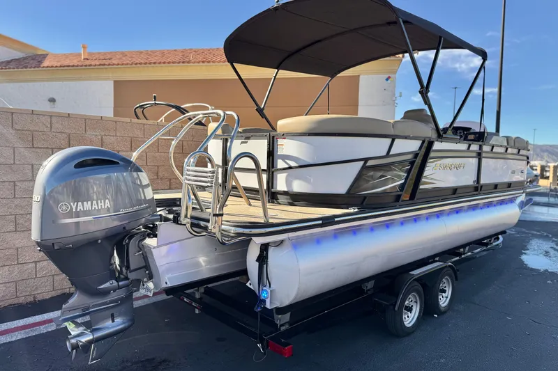 Slide: The Image of 2021 Starcraft SLS 3 pontoon boat with Yamaha outboard motor on trailer. - 6