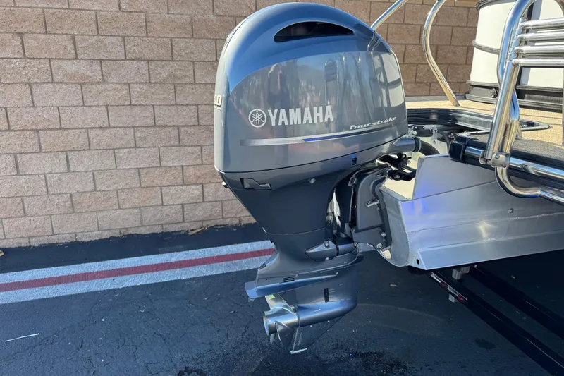 Slide: The Image of 2021 Starcraft SLS 3 with Yamaha outboard motor, parked on asphalt near brick wall. - 7