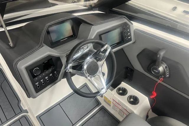 Slide: The Image of 2025 Cobalt CS23 Surf boat dashboard with modern controls and steering wheel. - 17