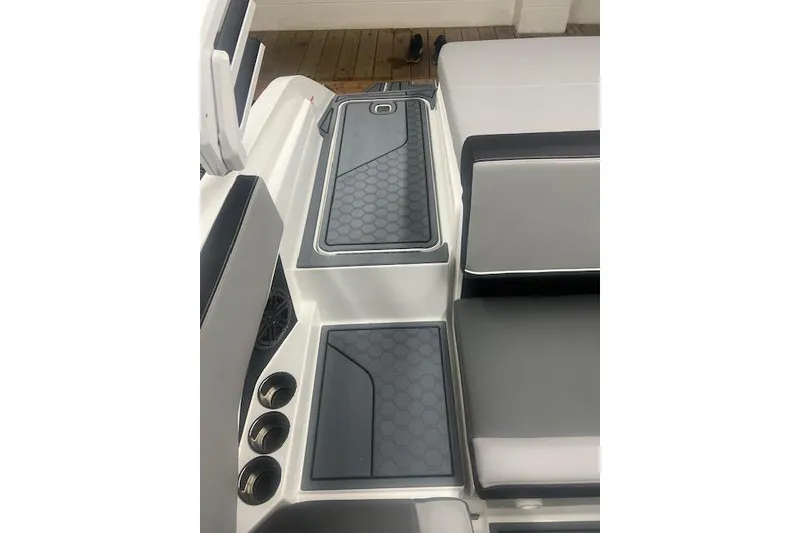 Slide: The Image of 2025 Cobalt CS23 Surf boat interior with sleek seating and hexagonal pattern flooring. - 22