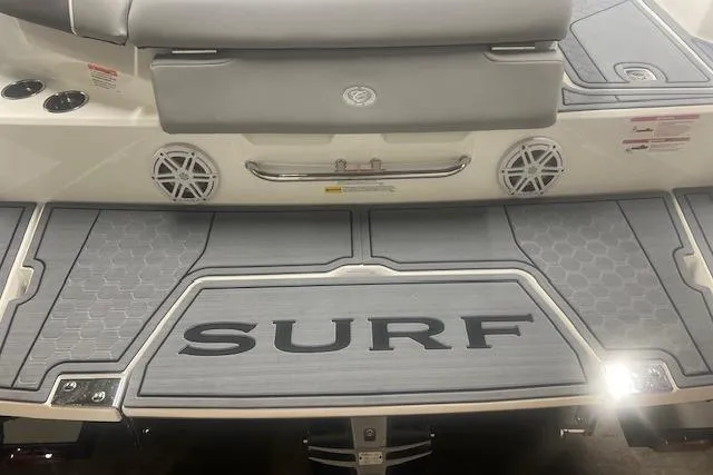 Slide: The Image of 2025 Cobalt CS23 Surf boat deck with "SURF" branding and sleek design. - 30