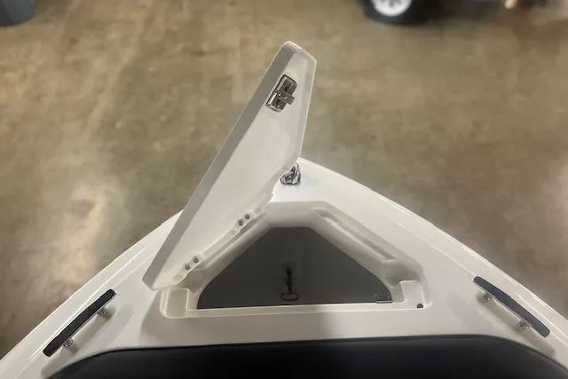 Slide: The Image of 2025 Cobalt CS23 Surf boat storage compartment with open hatch, showcasing interior space. - 5