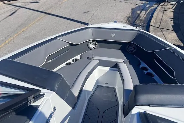 Slide: The Image of 2025 Cobalt CS23 Surf boat interior with gray seating and speakers. - 6