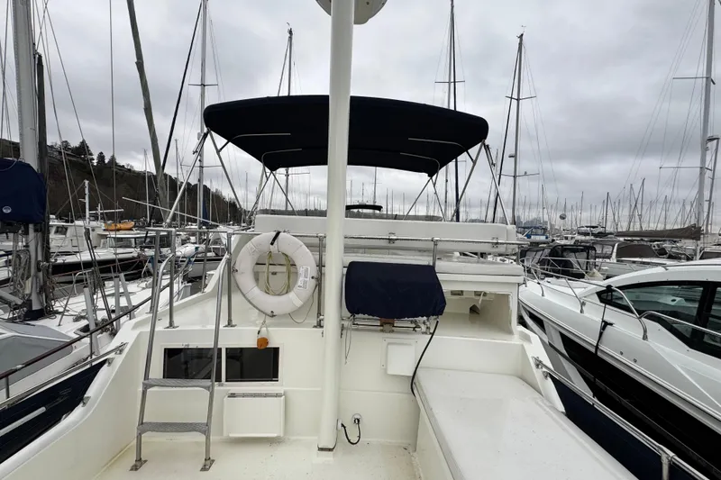 Slide: The Image of 1974 Tollycraft 40 Tri-Cabin MY yacht docked in a marina, overcast sky. - 1