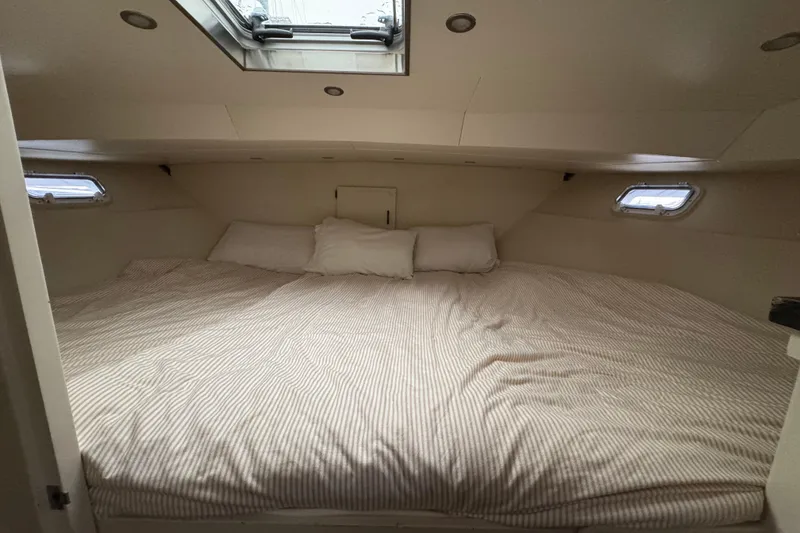 Slide: The Image of Cozy cabin interior of 1974 Tollycraft 40 Tri-Cabin MY with skylight and bedding. - 18