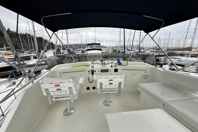 Slide: The Image of 1974 Tollycraft 40 Tri-Cabin MY boat interior with helm, seating, and marina view. - 24