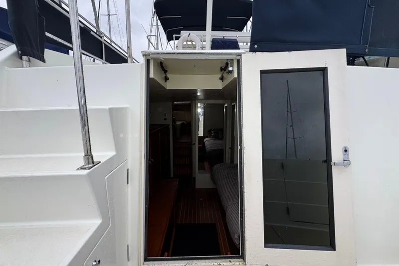 Slide: The Image of 1974 Tollycraft 40 Tri-Cabin MY yacht interior view with open door and visible cabin. - 25