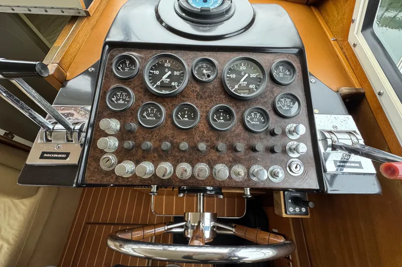 Slide: The Image of 1974 Tollycraft 40 Tri-Cabin MY helm with gauges and controls. - 7