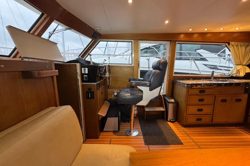 Slide: The Image of 1974 Tollycraft 40 Tri-Cabin MY interior with helm, seating, and kitchenette. - 10