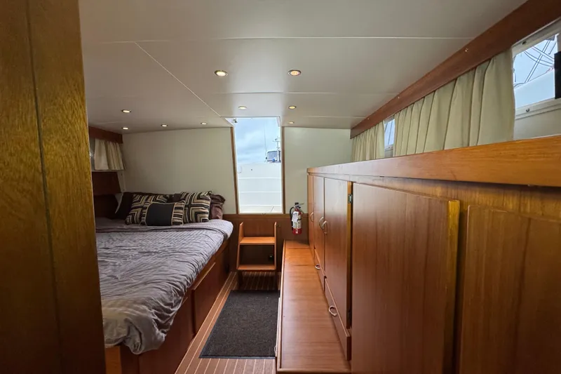 Slide: The Image of Cozy cabin interior of 1974 Tollycraft 40 Tri-Cabin MY with wood paneling and bed. - 12