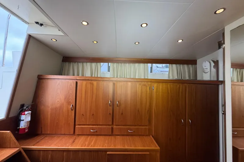 Slide: The Image of 1974 Tollycraft 40 Tri-Cabin MY interior with wooden cabinets and recessed lighting. - 13