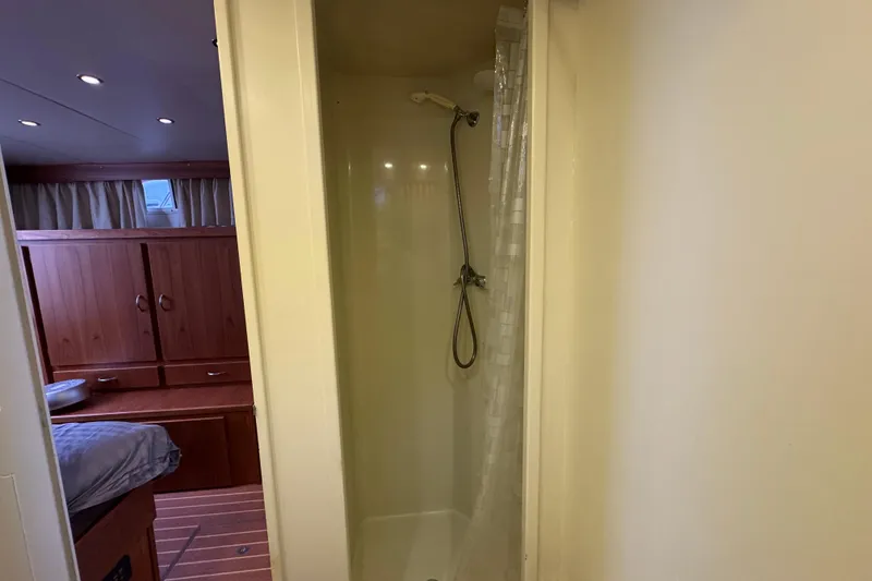 Slide: The Image of Shower area in 1974 Tollycraft 40 Tri-Cabin MY with adjacent wooden cabinetry. - 15
